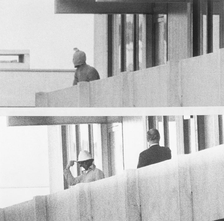 A member of the International Olympic Committee, right, speaks with a masked Palestine Liberation Organization terrorist 