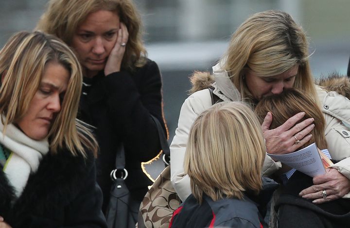 A woman comforts a boy as mourners leave the funeral for 6-year-old Jack Pinto on Dec. 17, 2012 in Newtown, Connecticut.