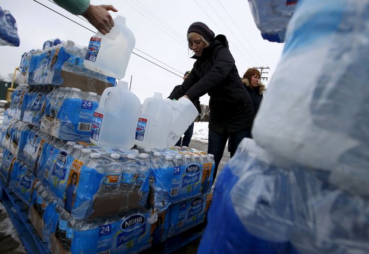 Volunteers distribute bottled water to help combat the effects of the crisis when the city's drinking water became contaminated with dangerously high levels of lead in Flint, Michigan, March 5, 2016.