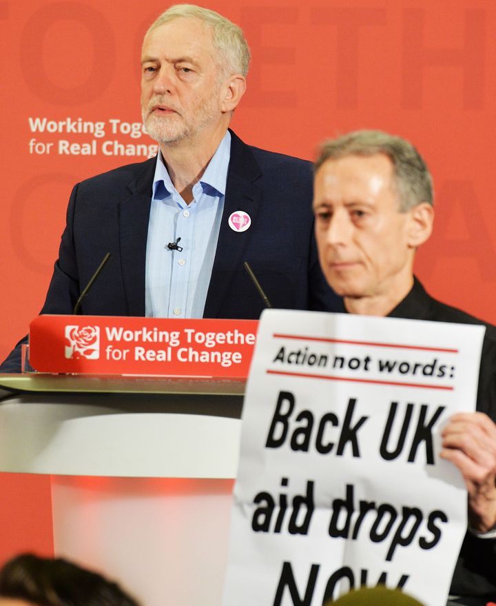 Corbyn (left) looks on as Tatchell (right) disrupts his speech in December.