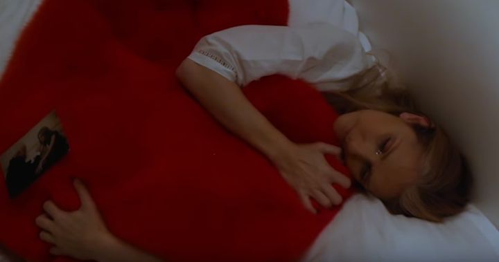 Celine curls up with a cushion in the emotional video