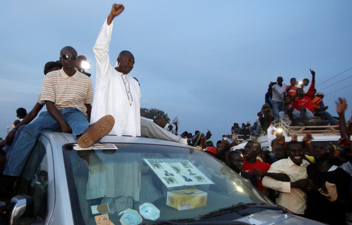 Supporters of Gambia's United Democratic Party opposition alliance cheer for candidate Adama Barrow during a rally in Banjul, Gambia, on Nov. 29, 2016. Barrow went on to win the election, but he has now been forced to flee Gambia for his safety.