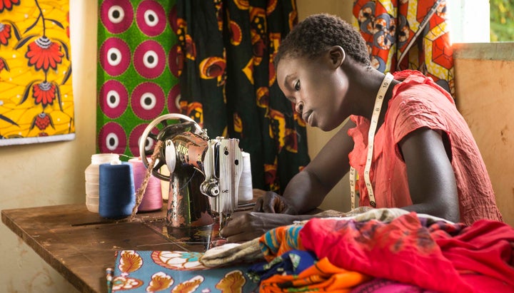 After Water.org installed a water pump in her village in Kenya, Elizabeth, 24, was able to focus on developing her work as a seamstress since she no longer had to spend four hours a day collecting water.