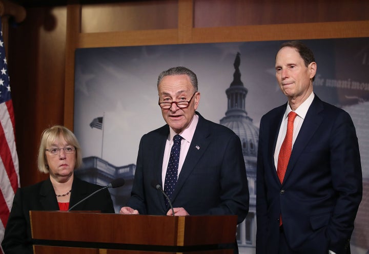 Senate Minority Leader Charles Schumer (D-NY) (C), speaks while flanked by Sen. Patty Murray (D-WA),(L), and Sen. Ron Wyden (