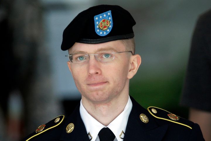 Chelsea Manning, then-Army Pfc Bradley Manning, is escorted out of a courthouse in Fort Meade 15 June 2013