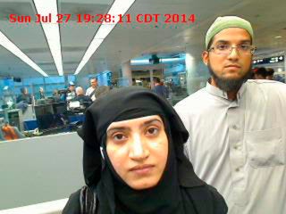 Tashfeen Malik, left, and Syed Farook are pictured passing through Chicago's O'Hare International Airport on July 27, 2014.