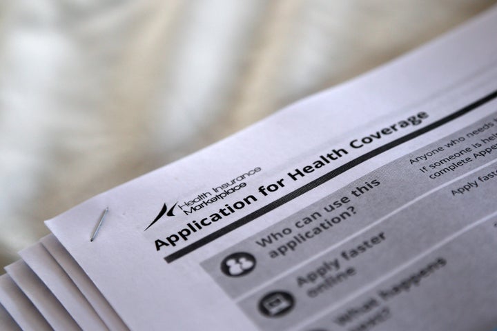 The federal government forms for applying for health coverage are seen at a rally held by supporters of the Affordable Care A
