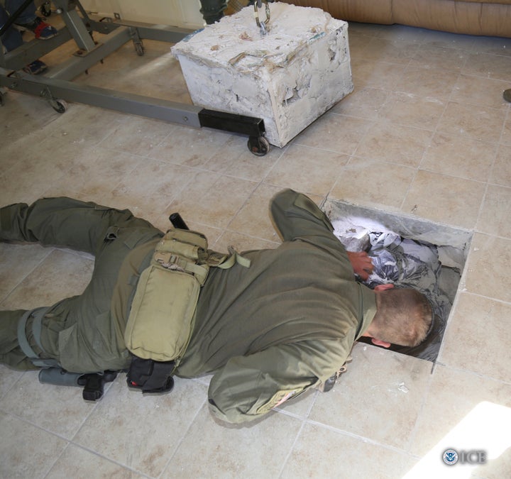 A U.S. Homeland Security Investigations Special Response Team agent is looking into a tunnel exit point during an investigati