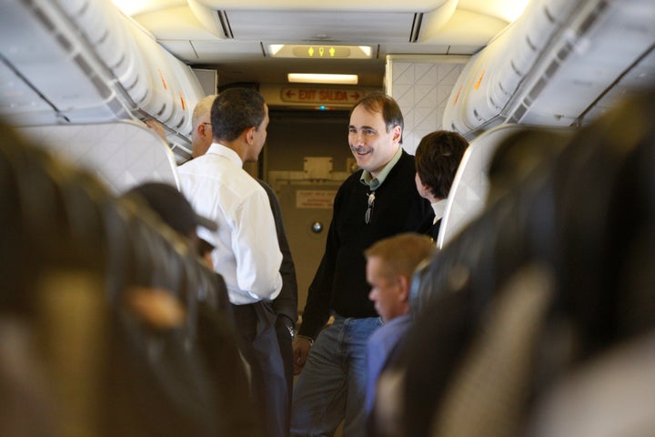 David Axelrod speaks with then-Sen. Barack Obama during a campaign flight from Boise, Idaho, to Minneapolis in Febr