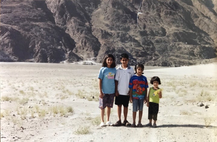 Mahira and her siblings stand on the Karakoram Highway in northern Pakistan while on their way to the Pakistan-China border d