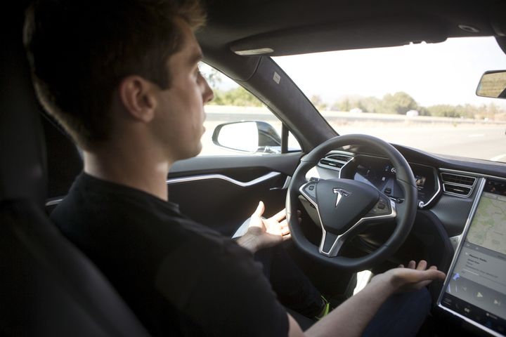 A driver demonstrates Autopilot features in a Tesla Model S in Palo Alto, California, in 2015.
