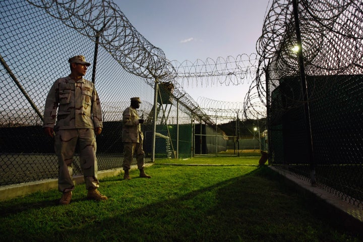 Guards stand outside a Guantanamo camp for Uighur detainees in October 2009.