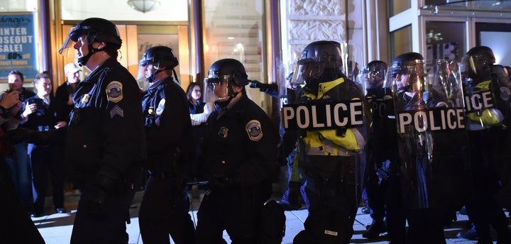 Police push back protesters outside the National Press Club where the Deplorable Ball is being held in Washington, DC on Thursday.