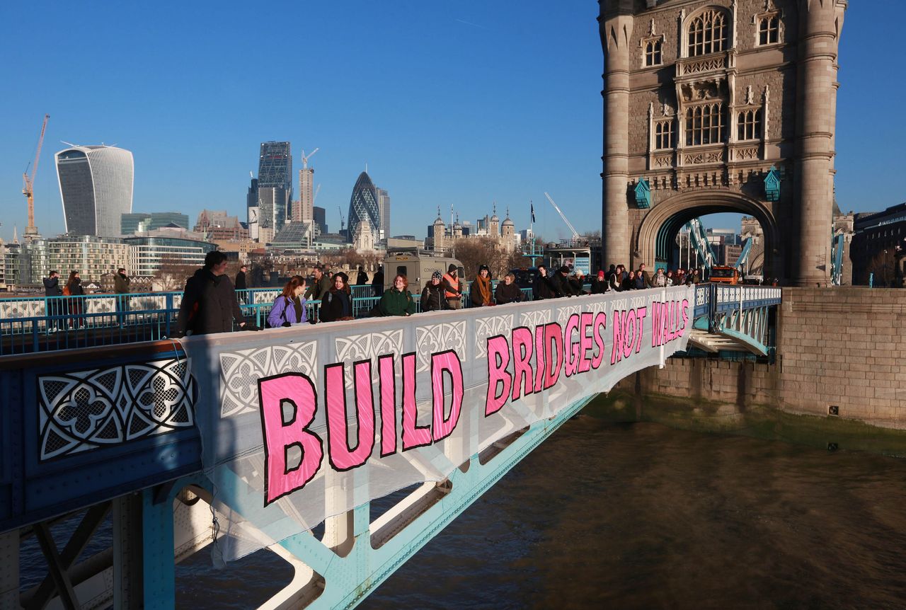 'Build bridges not walls' banned hangs over Tower Bridge.