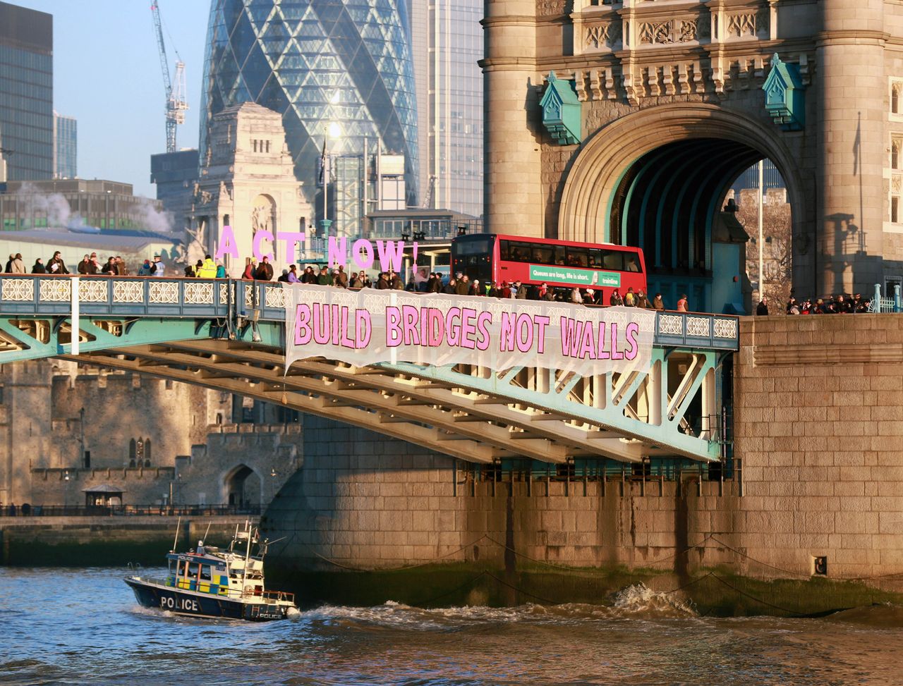 A banner is unfurled on London's Tower Bridge, organised by Bridges Not Walls.