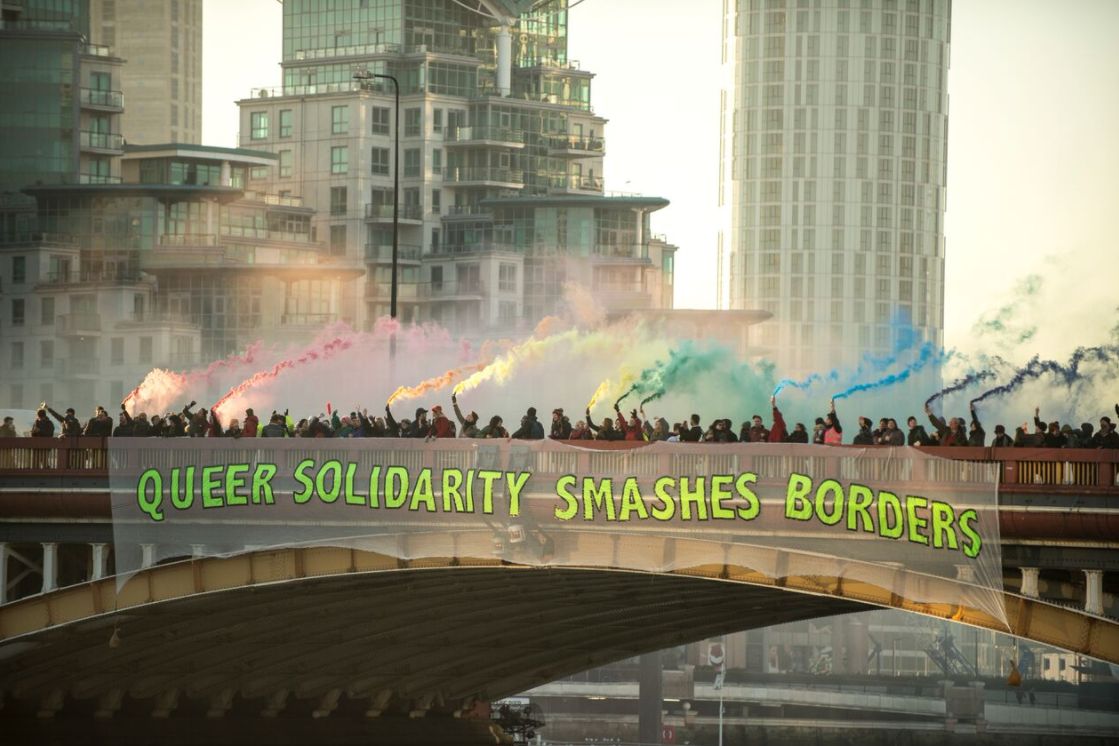Demonstrators hang a banner that reads "Queer Solidarity Smashes Borders" from Vauxhall Bridge during a protest against the inauguration of Donald Trump as U.S. President.