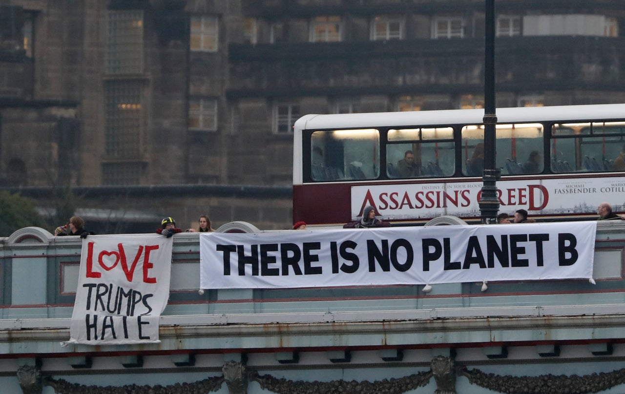 <strong>Demonstrators hang a banner at North Bridge during a protest against the inauguration of Donald Trump.</strong>