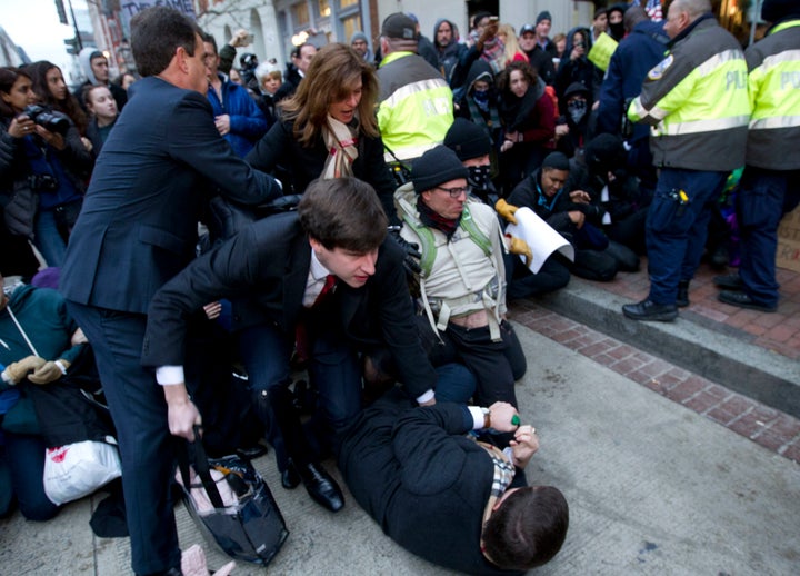 Inaugural attendees move through demonstrators attempting to block people entering a security checkpoint