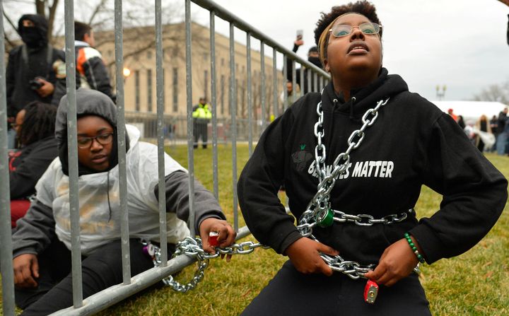Protesters chain themselves to an entry point prior at the inauguration in Washington.