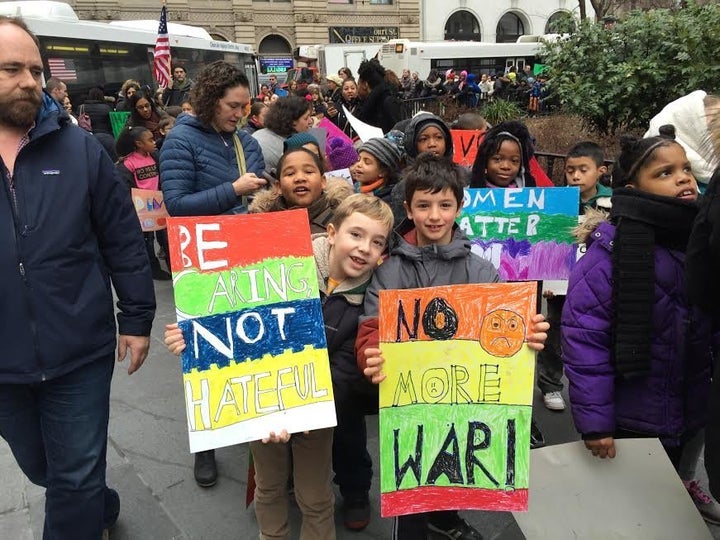 George and Micah, 8-year-old students from PS 261 in Brooklyn, New York, were out protesting hate on Friday.