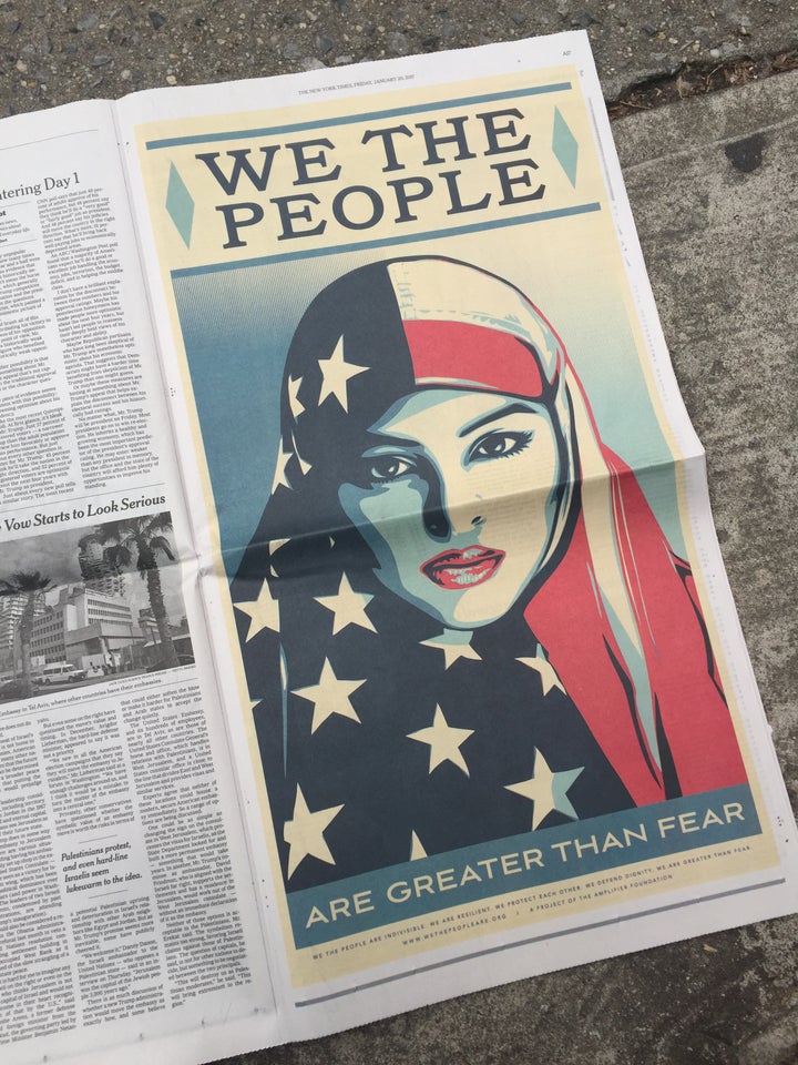 A photo of Shepard Fairey's "We The People" ad in The New York Times.