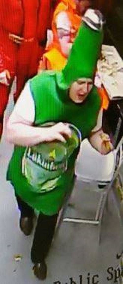 Police in South Wales U.K. are looking for a man accused of stealing two pizzas while dressed as a beer bottle.