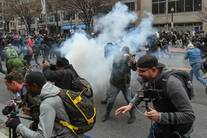 Protesters and journalists scramble as stun grenades are deployed by police