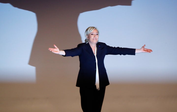 France's National Front leader Marine Le Pen gestures after her speech during a European far-right leaders meeting to discuss