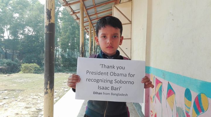 In this picture, Dihan is promoting the story of President Obama & Soborno Isaac at his school Here