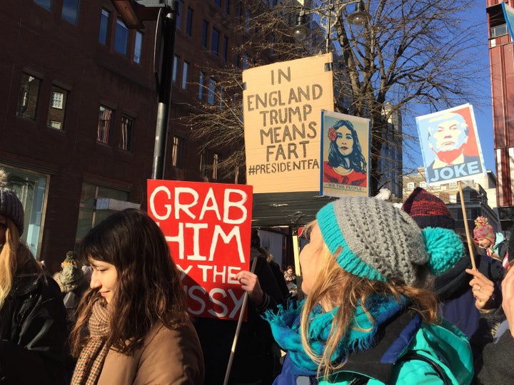 Demonstrators carry signs at the Women's March in London.