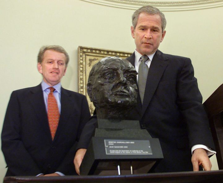 George W. Bush inspects a bust of Winston Churchill presented by the British Ambassador Christopher Meyer in July 2001