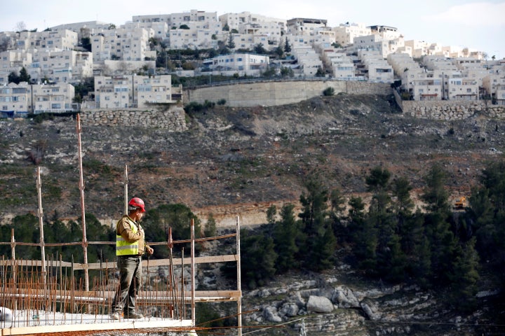 A laborer works at a construction site in the Israeli settlement of Ramot. Jerusalem’s City Hall approved the building permits for more than 560 units in Pisgat Zeev, Ramat Shlomo and Ramot. 