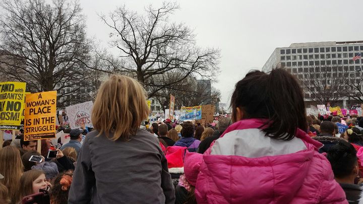 Two young girls* being held up during the Women’s March in Washington, D.C. 