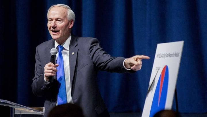 At a town hall in Conway, Arkansas, Gov. Asa Hutchinson warns about the consequences of ending health care coverage in a rura