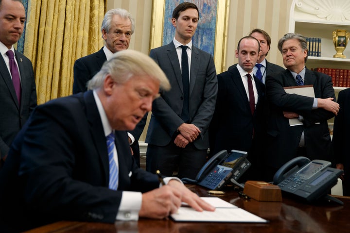 <strong>L-R: White House Chief of Staff Reince Priebus, National Trade Council adviser Peter Navarro, Senior Adviser Jared Kushner, policy adviser Stephen Miller, and chief strategist Steve Bannon watch Trump sign the executive order</strong>