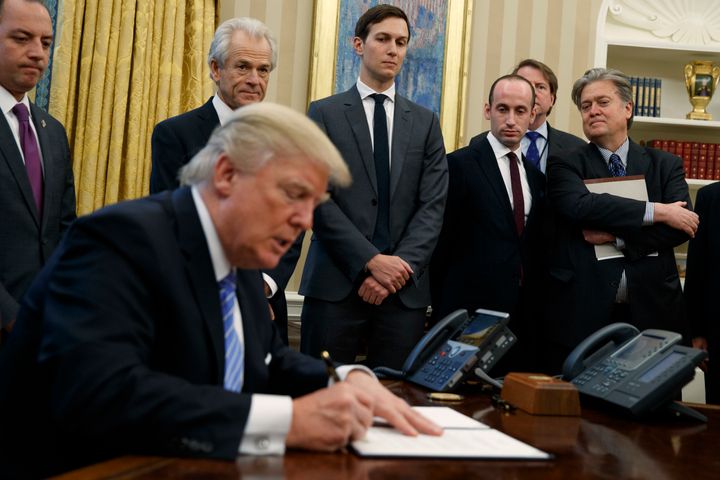 L-R: White House Chief of Staff Reince Priebus, National Trade Council adviser Peter Navarro, Senior Adviser Jared Kushner, policy adviser Stephen Miller, and chief strategist Steve Bannon watch Trump sign the executive order