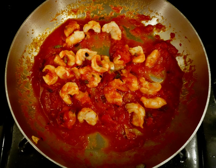 <p>When the pasta is nearly done, shrimp and sage go into the skillet</p>