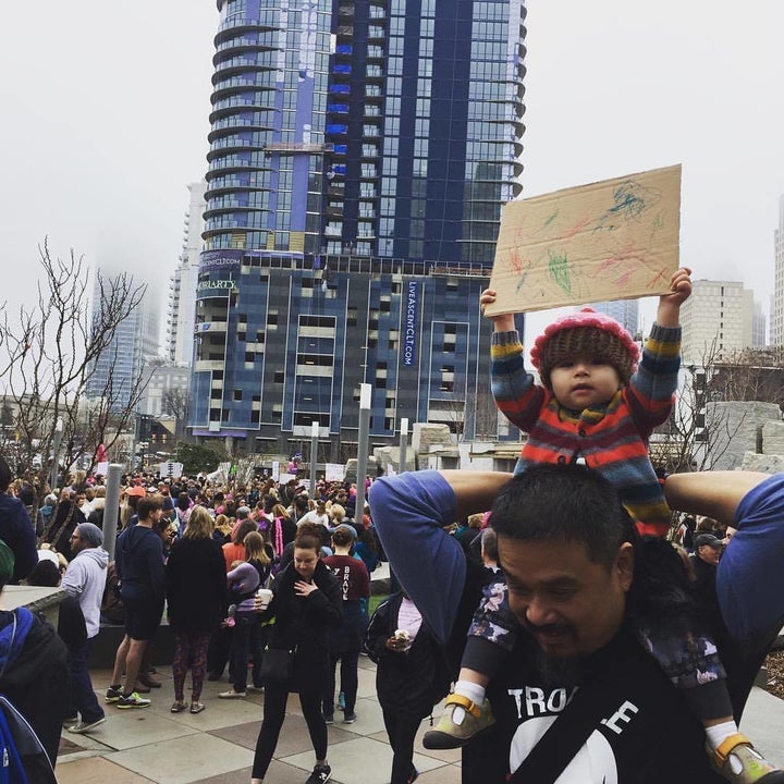 Sowry’s daughter holding the sign she made.