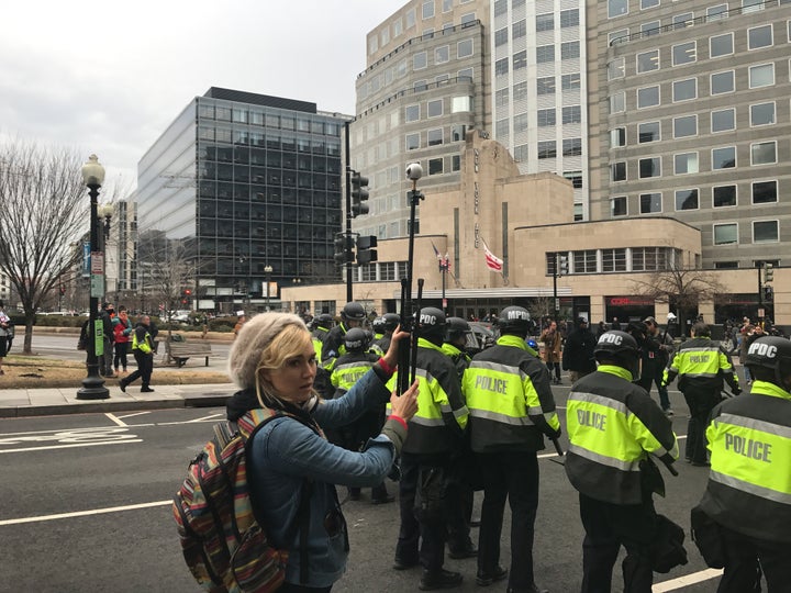 RYOT’s Nora Kirkpatrick holds a Samsung Gear360 camera over the heads of riot police on Inauguration Day, Washington D.C.