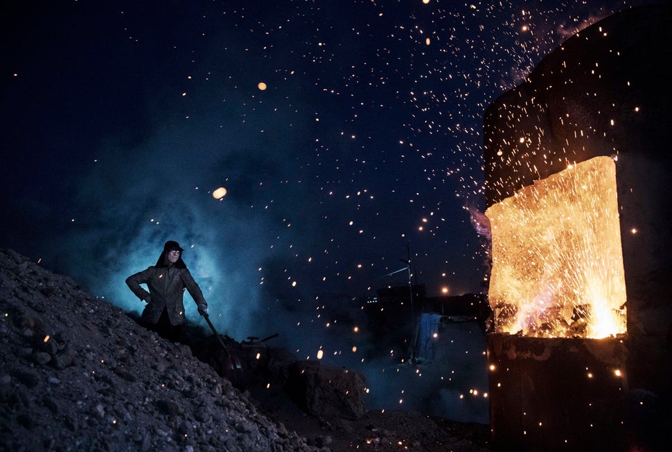 A Chinese laborer stands near a furnace at an unauthorized steel factory on Nov. 3, 2016 in Inner Mongolia, China.