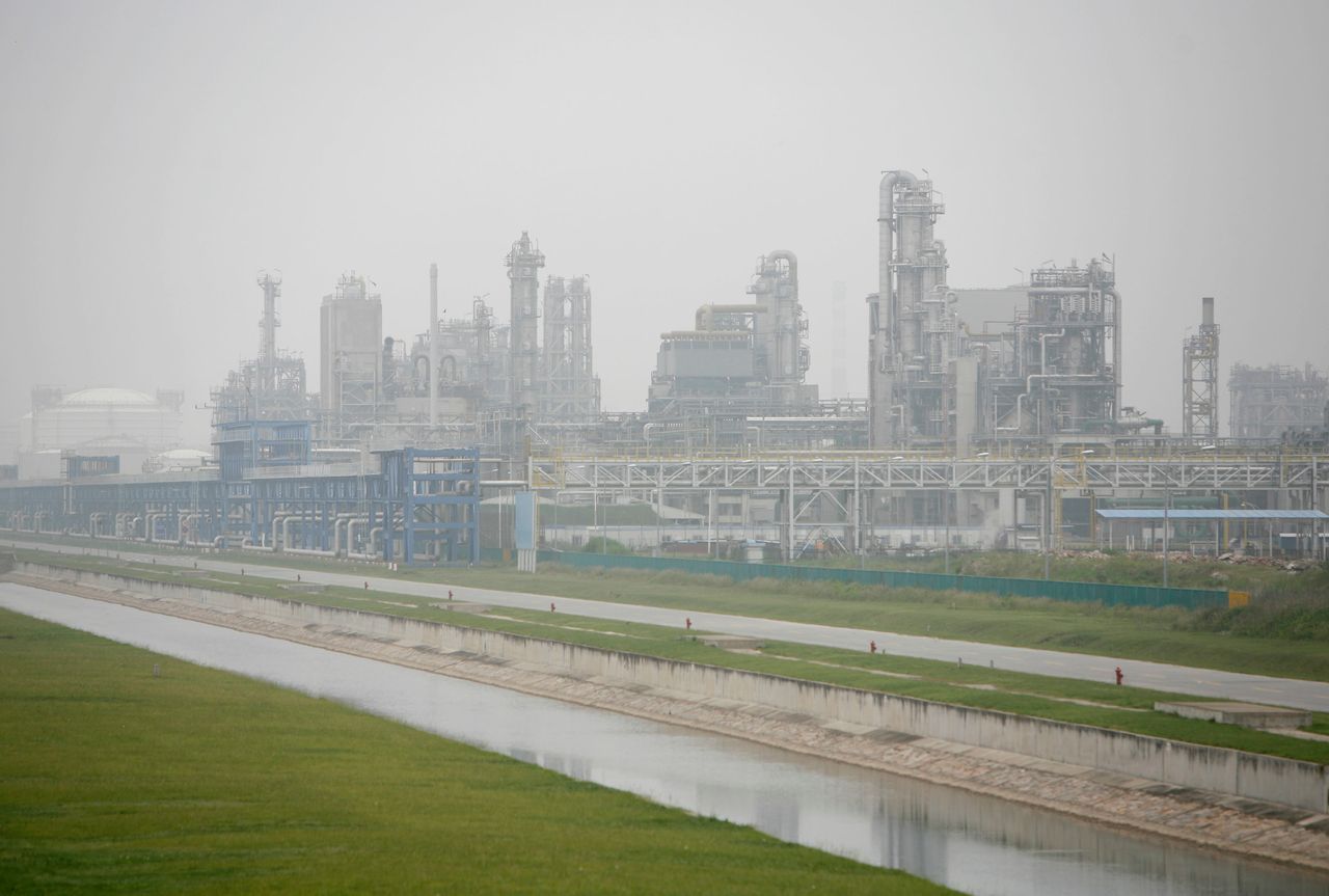 Water runs past a petrochemical plant at the Shanghai Chemical Industry Park. May 29, 2007.