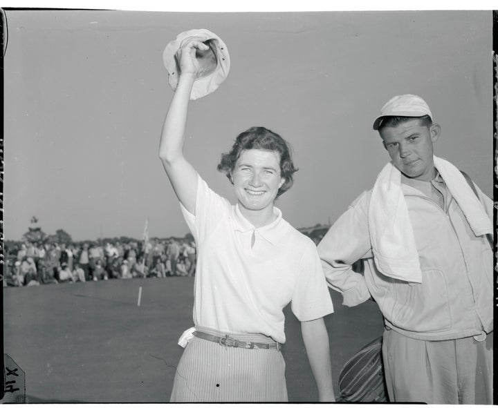 Suggs, 26, holds the Women's National Open golf championship trophy, which she won at the Prince Georges Golf Club.