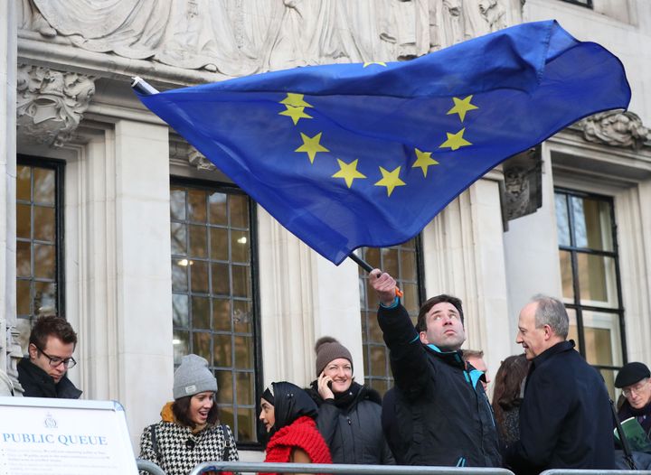 A man waves a flag outside the Supreme Court shortly before the ruling was officially announced