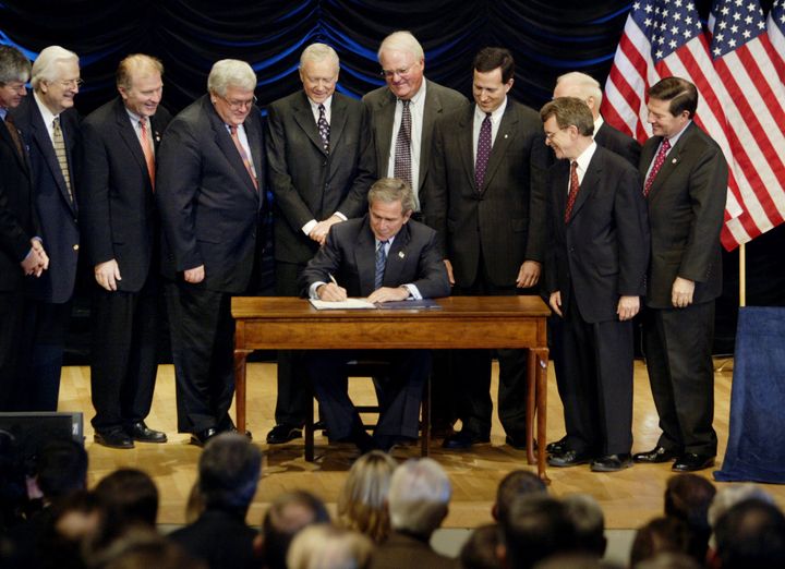 Surrounded by lawmakers, then US President George W. Bush signs legislation banning so-called partial birth abortions in Washington November 5, 2003