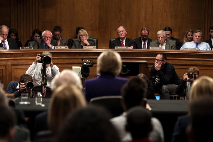 Senate Health, Education, Labor, and Pensions Committee members listen as Donald Trump's pick for secretary of education, Betsy DeVos, speaks during her confirmation hearing.