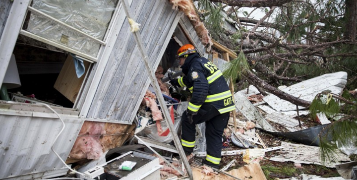 Fire and rescue crews search through devastated homes in Albany, GA looking for survivors who might have been trapped.