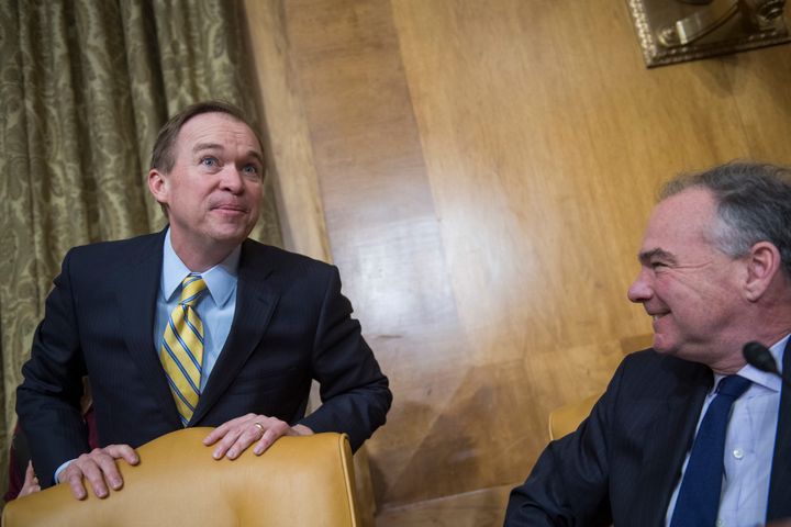 Rep. Mick Mulvaney (R-S.C.), left, talks with Sen. Tim Kaine (D-Va.) before his confirmation hearing on Jan. 24. Kaine later interrogated Mulvaney about climate change.