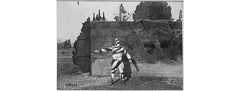 A soldier in World War I models early camouflage, 1917.