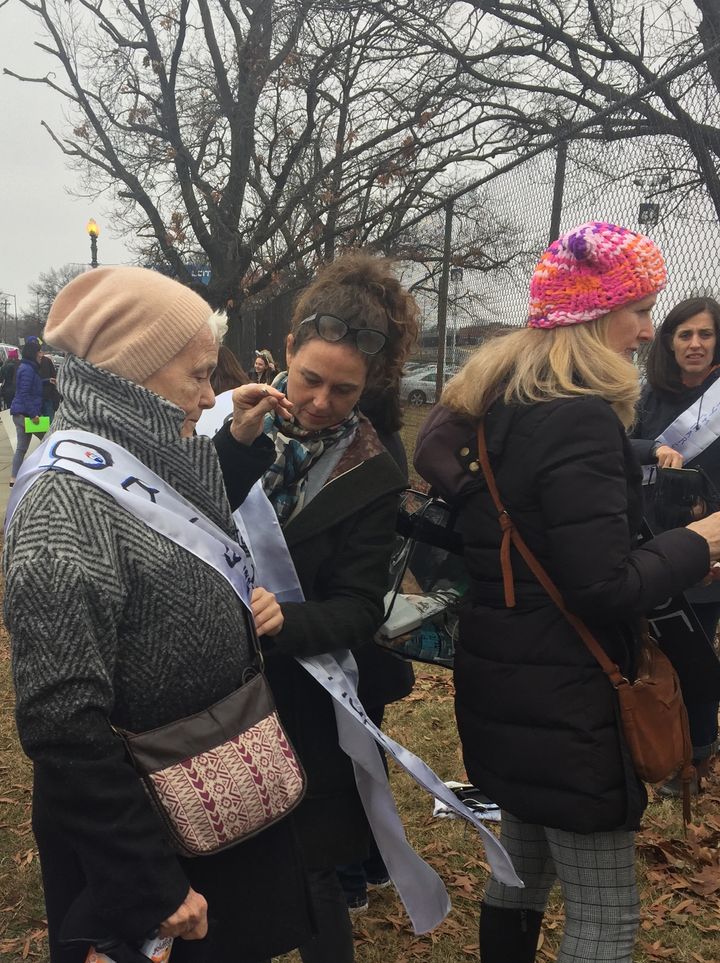 A mother and daughter in my group help each other to get ready for the march.