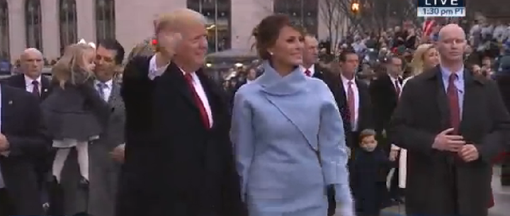 There has been speculation that the bodyguard (pictured right) was wearing prosthetic arms to conceal a rifle beneath his overcoat 